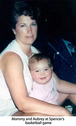 A woman holding a baby in her arms.